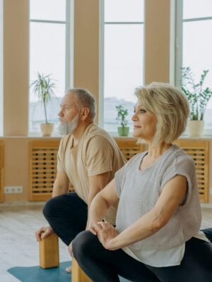 Man in Gray Tank Top Sitting Beside Woman in Gray Tank Top