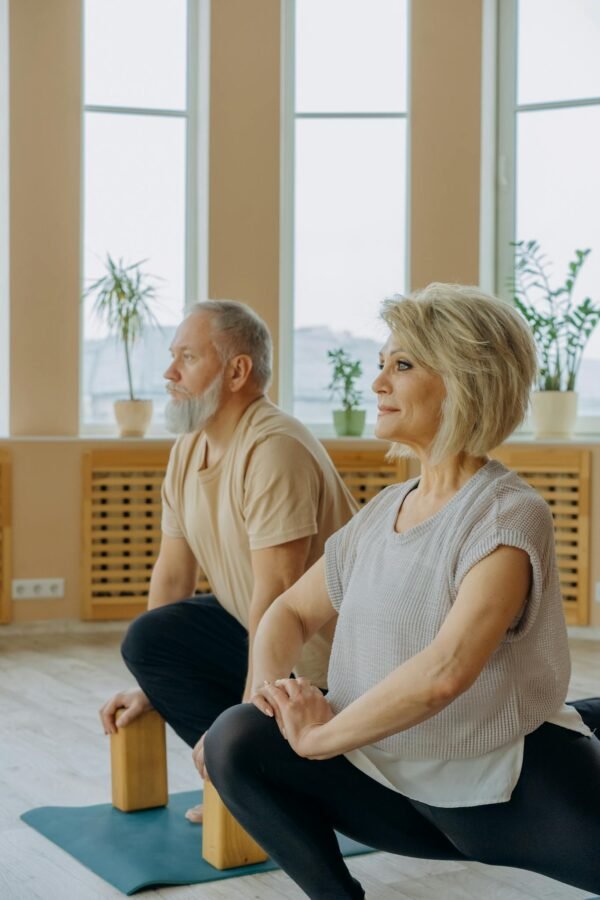 Man in Gray Tank Top Sitting Beside Woman in Gray Tank Top